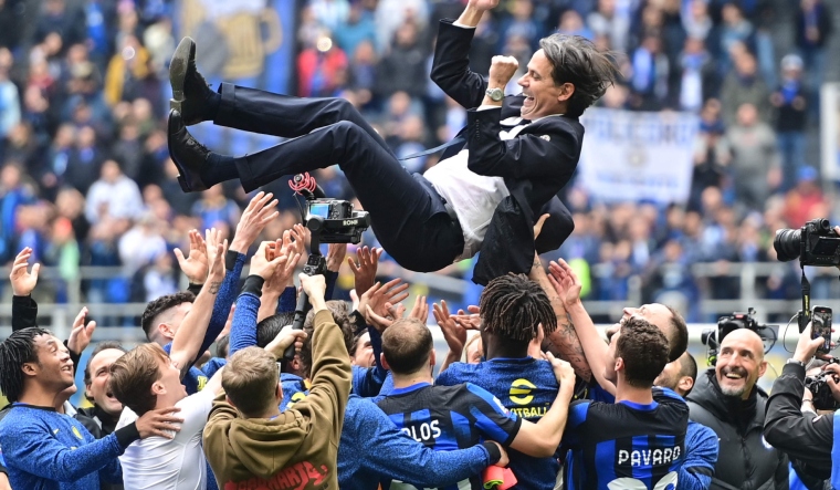 Inter Milan's Italian coach Simone Inzaghi is tossed in the air by players to celebrate the scudetto | AFP